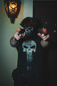 a man in a punisher costume holding a gun