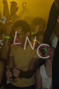 a crowd of people at a party with the word lnc