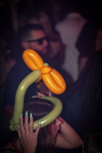 a woman wearing a balloon hat at a party