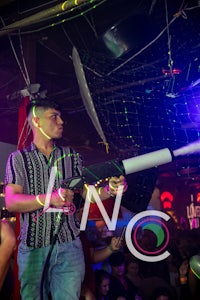 a man holding a gun at a party