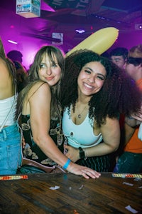 two women posing for a picture at a party