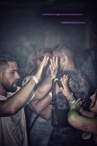 a group of people dancing at a night club